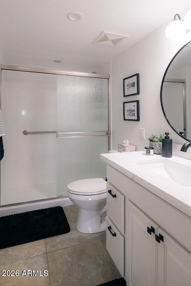 7940 East Camelback Road, Unit 608 Scottsdale, AZ 85251 - Photo 18 of 45 a bathroom with a toilet a sink a mirror and a shower