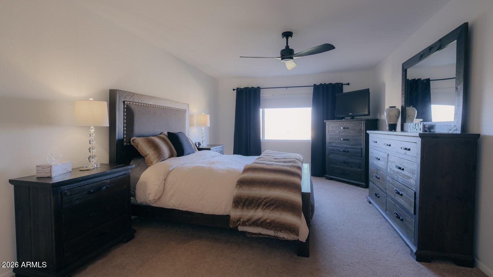 7940 East Camelback Road, Unit 608 Scottsdale, AZ 85251 - Photo 19 of 45 a bedroom with a bed and a chandelier