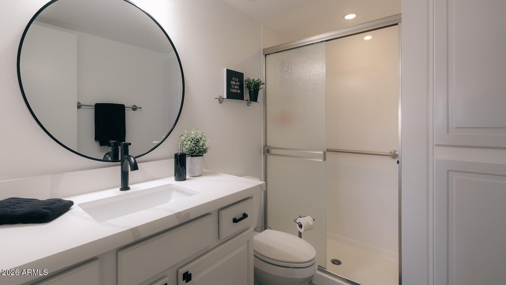 7940 East Camelback Road, Unit 608 Scottsdale, AZ 85251 - Photo 22 of 45 a bathroom with a sink a toilet and a mirror