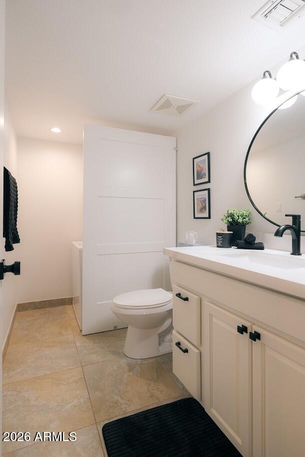 7940 East Camelback Road, Unit 608 Scottsdale, AZ 85251 - Photo 25 of 45 a bathroom with a toilet sink and mirror