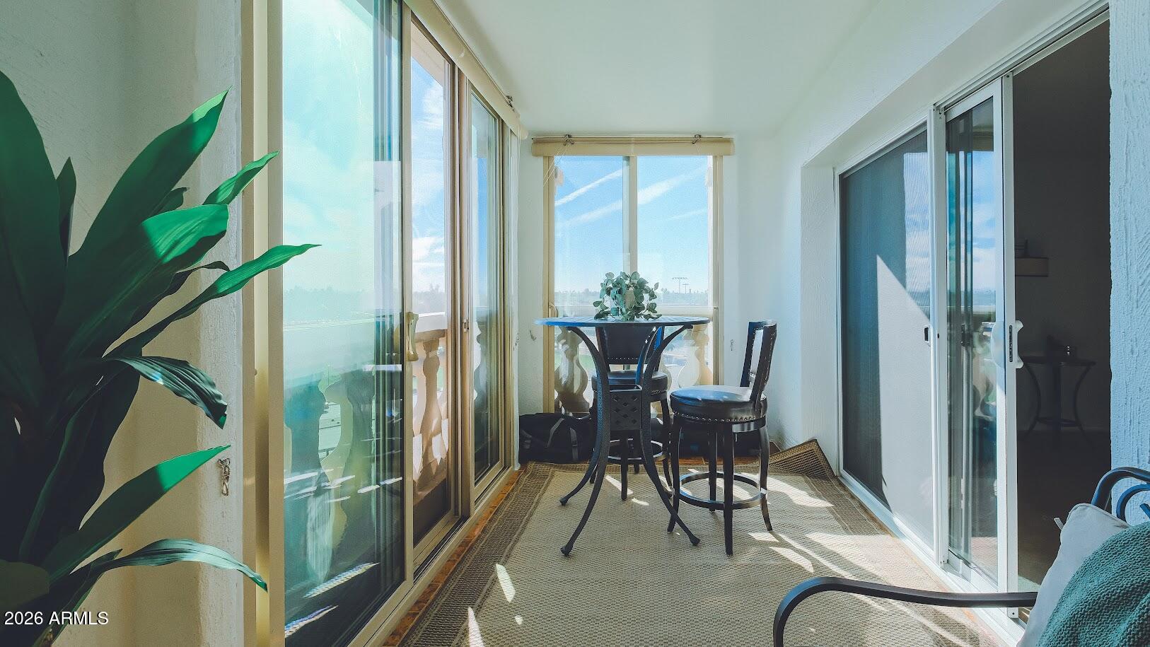 7940 East Camelback Road, Unit 608 Scottsdale, AZ 85251 - Photo 29 of 45 a balcony with chairs and entryway