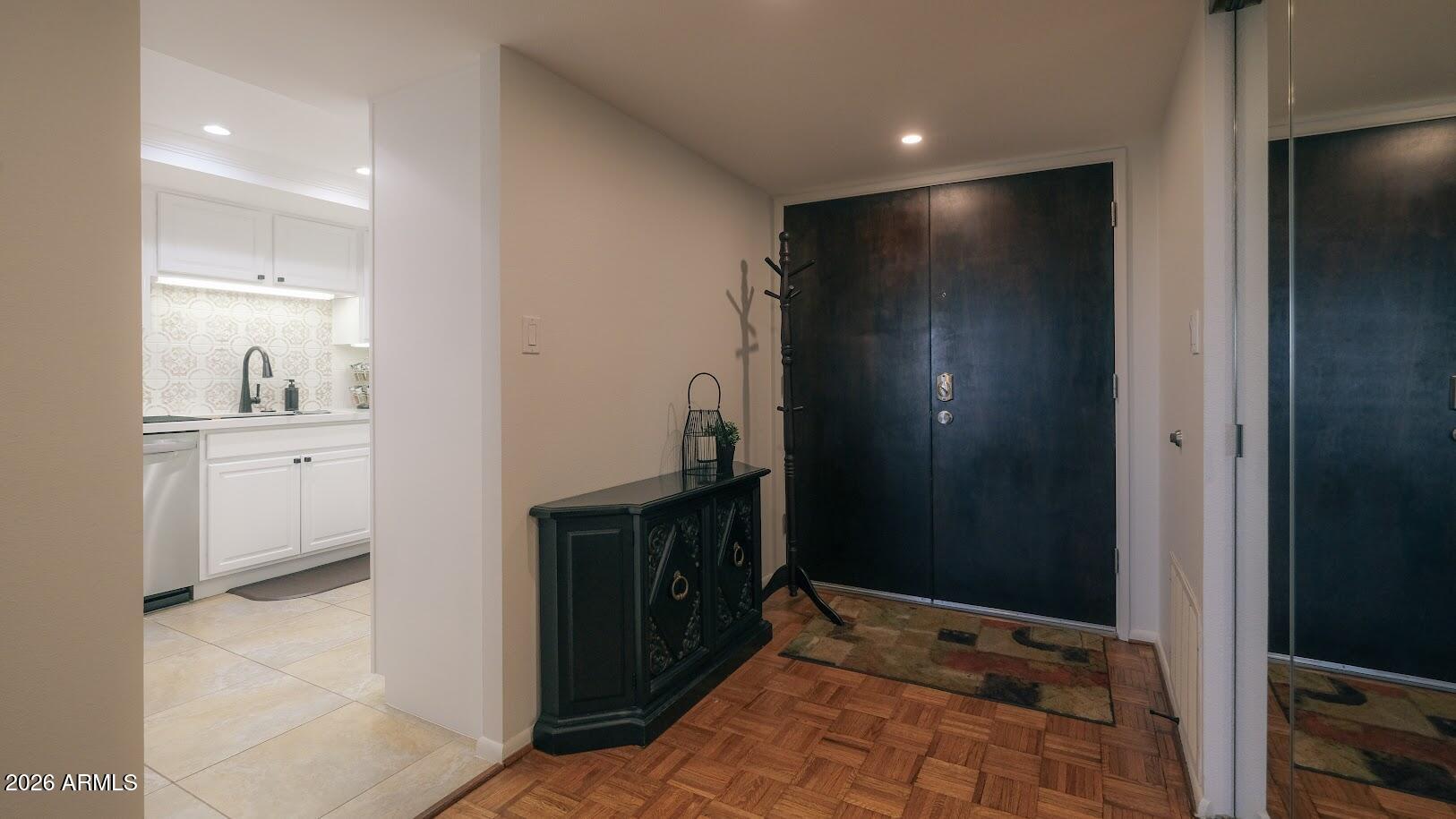 7940 East Camelback Road, Unit 608 Scottsdale, AZ 85251 - Photo 33 of 45 a view of hallway with a large mirror and a sink