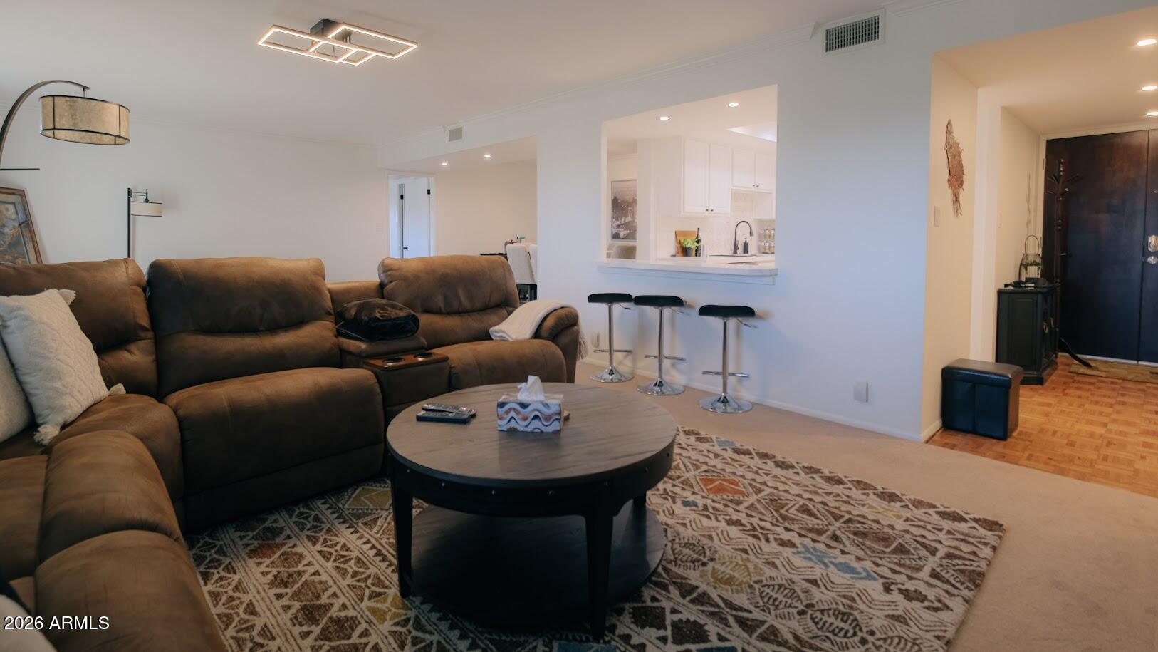 7940 East Camelback Road, Unit 608 Scottsdale, AZ 85251 - Photo 7 of 45 a living room with furniture and a flat screen tv