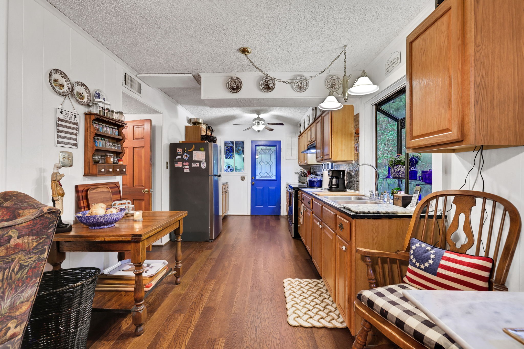 300 Timber Lane Coldspring, TX 77331 - Photo 9 of 43 a kitchen with stainless steel appliances granite countertop a sink and wooden floors