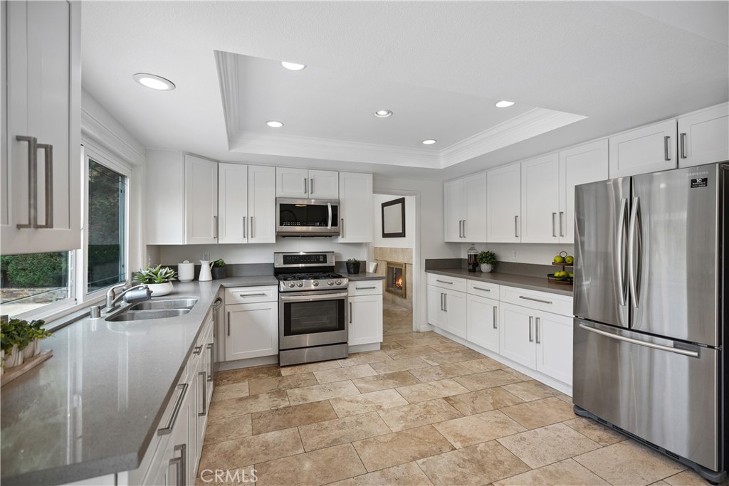 15 Colonial Irvine, CA 92620 - Photo 16 of 42 a kitchen with granite countertop a refrigerator stove top oven and sink