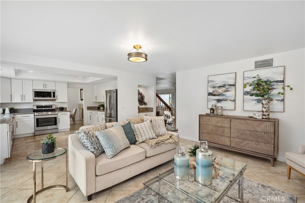 15 Colonial Irvine, CA 92620 - Photo 21 of 42 a living room with furniture kitchen view and a wooden floor