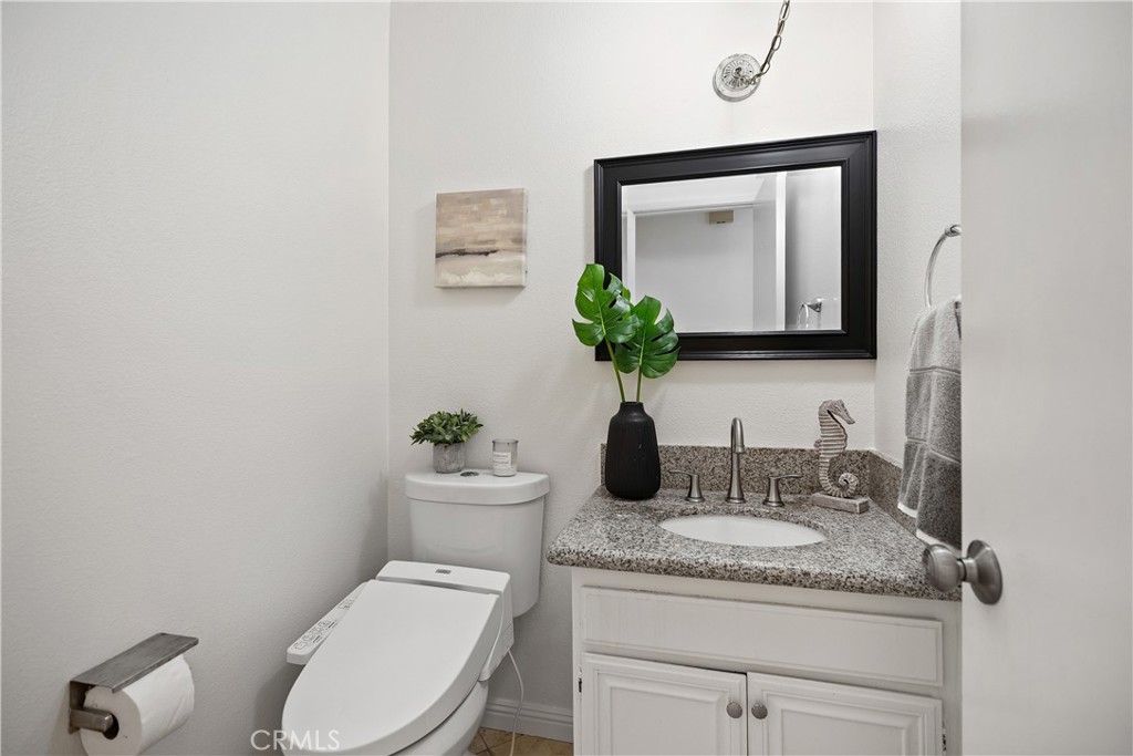 15 Colonial Irvine, CA 92620 - Photo 23 of 42 a bathroom with a granite countertop toilet sink and mirror