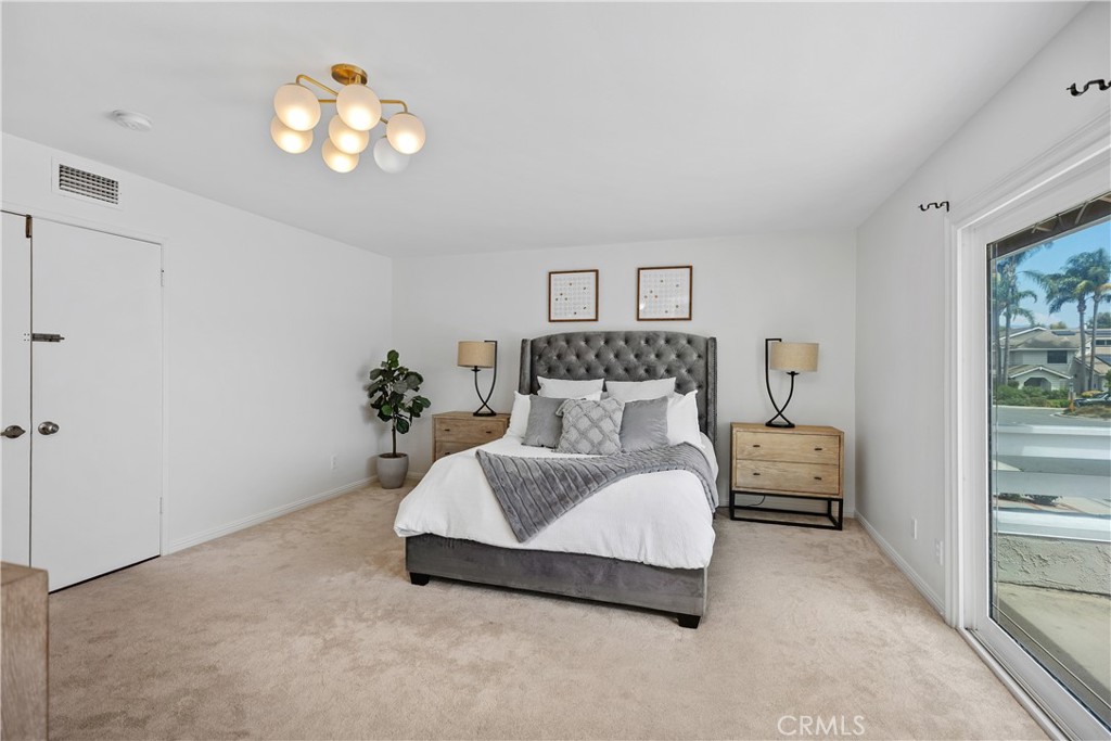 15 Colonial Irvine, CA 92620 - Photo 24 of 42 a bedroom with a bed and a chandelier