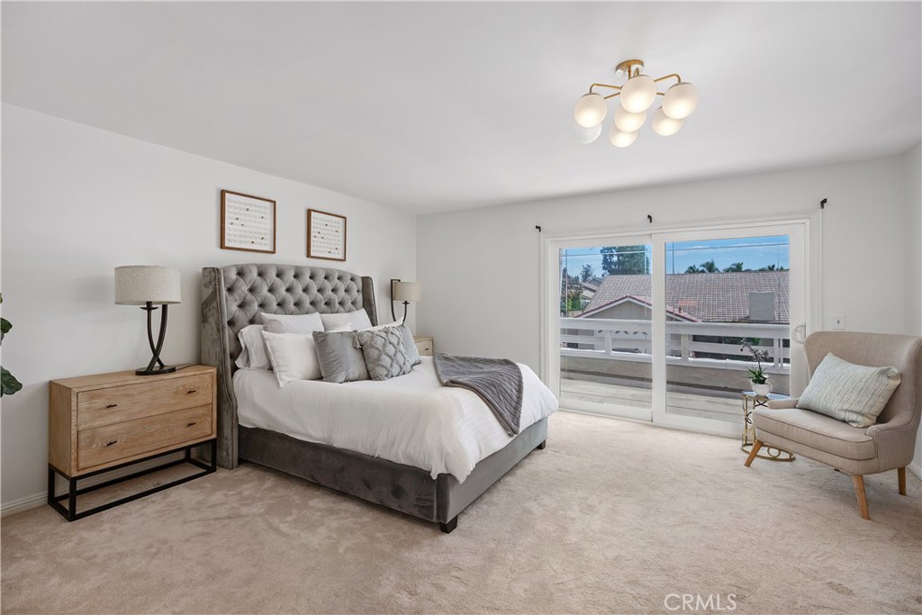 15 Colonial Irvine, CA 92620 - Photo 25 of 42 a spacious bedroom with a bed a couch and cabinet