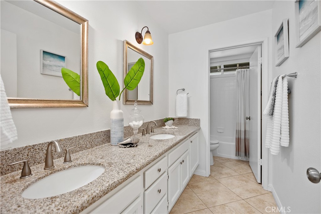 15 Colonial Irvine, CA 92620 - Photo 33 of 42 a bathroom with a granite countertop sink and a mirror