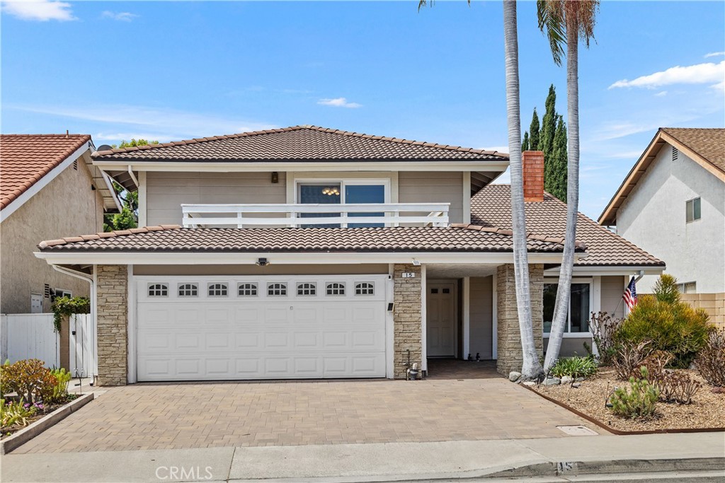 15 Colonial Irvine, CA 92620 - Photo 5 of 42 a front view of a house with a garden and garage