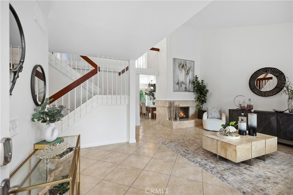 15 Colonial Irvine, CA 92620 - Photo 7 of 42 a living room with furniture a fireplace and potted plants
