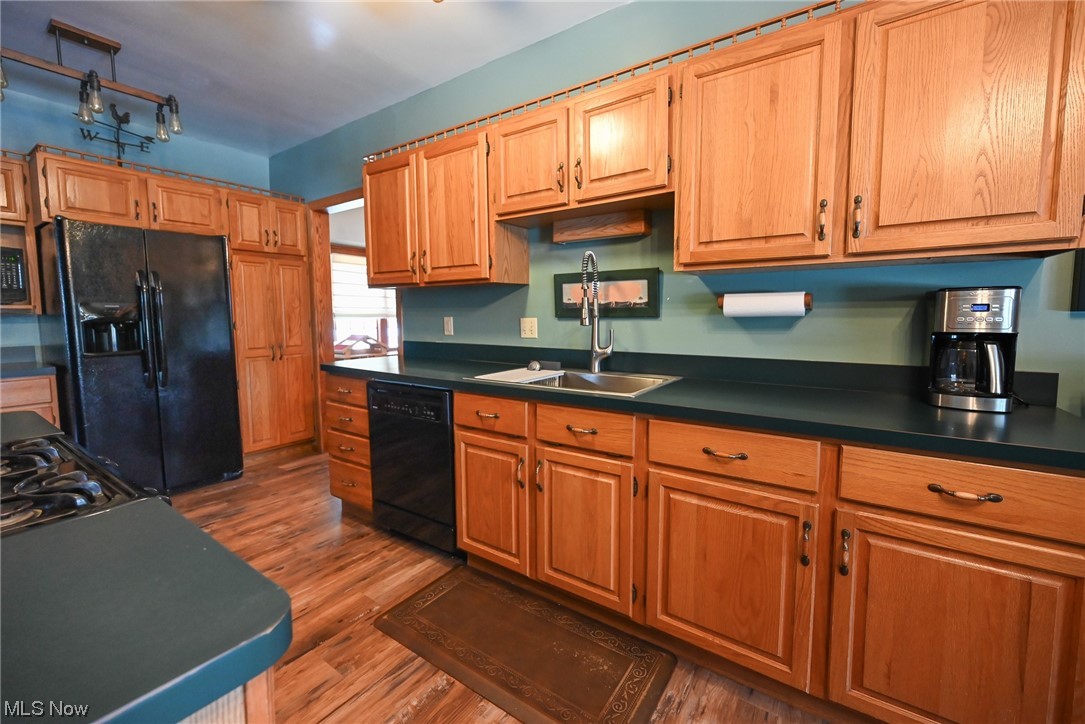 4436 Ridge Road Brooklyn, OH 44144 - Photo 10 of 33 Oak Kitchen with newer flooring, black appliances, and lots of cabinet space