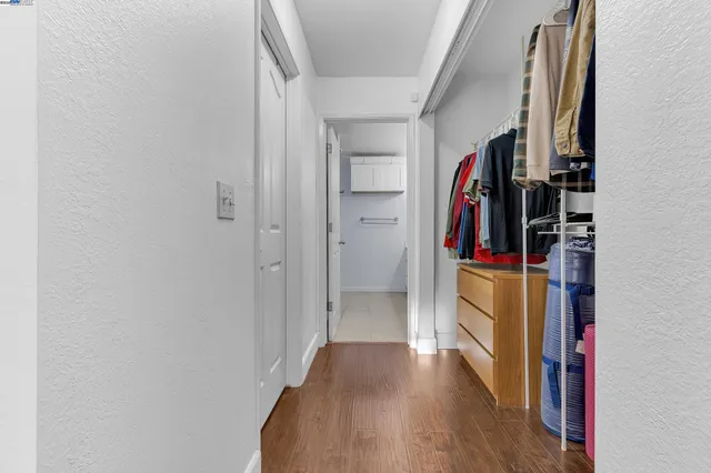 a view of walk in closet with clothes and shoes