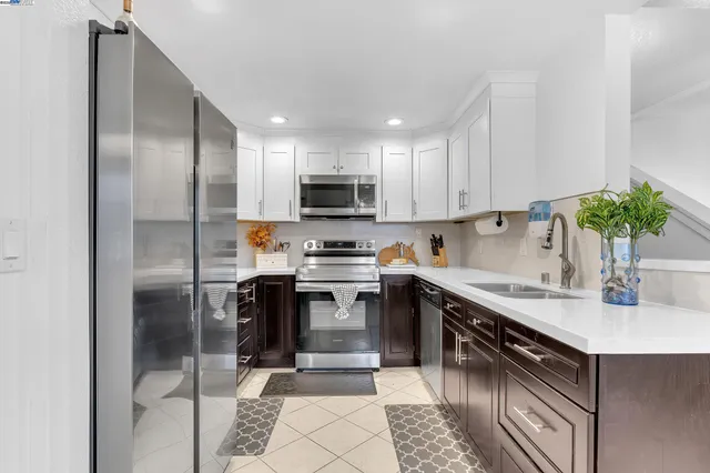 a kitchen with a sink stainless steel appliances and cabinets