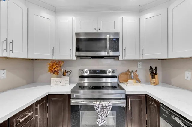 a kitchen with a stove and a white cabinets