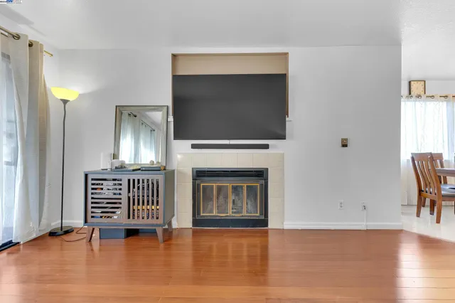 a view of livingroom with furniture fireplace and wooden floor