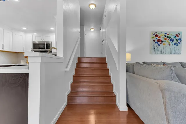 a view of entryway and hall with wooden floor