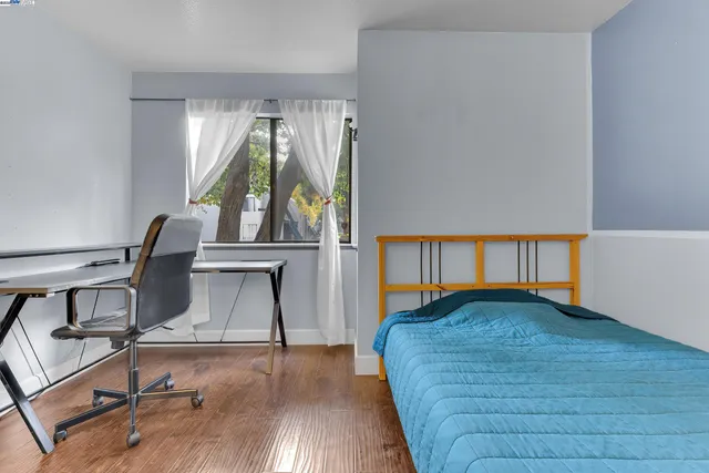 a living room with a bed furniture and a window