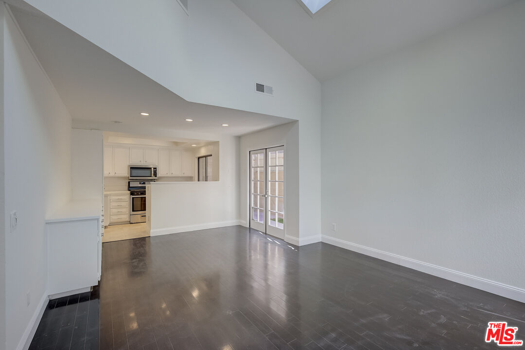 117 East Wilson Street, Unit C Costa Mesa, CA 92627 - Photo 13 of 23 a view of a kitchen with wooden floor and a window