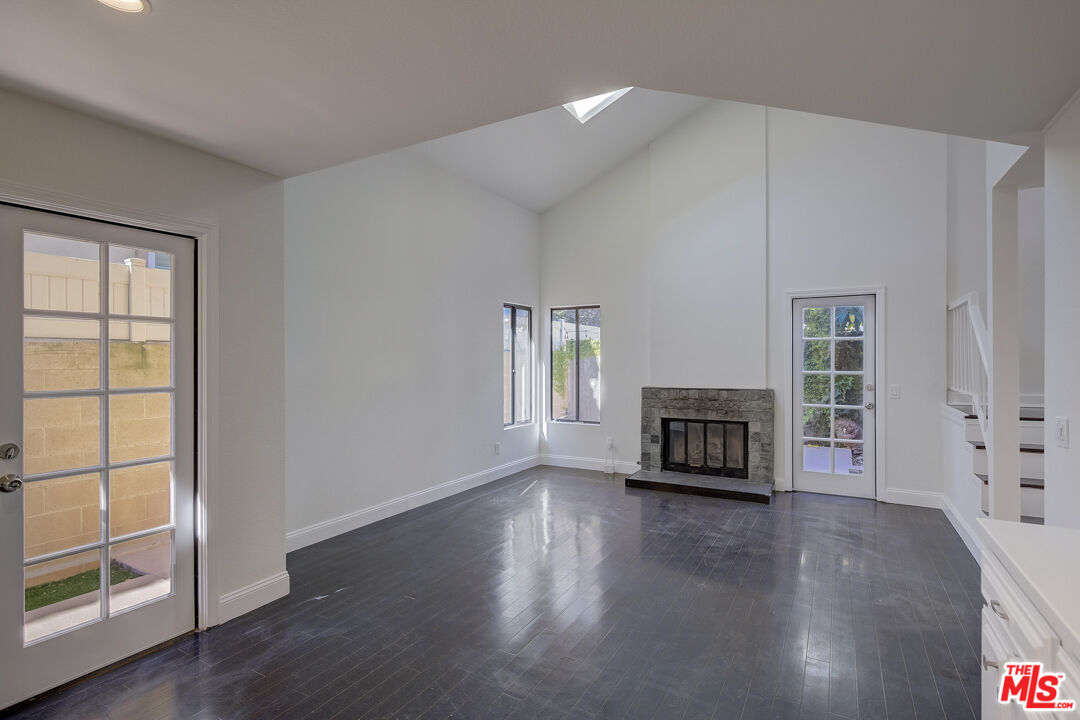 117 East Wilson Street, Unit C Costa Mesa, CA 92627 - Photo 14 of 23 an empty room with floor to ceiling window and wooden floor