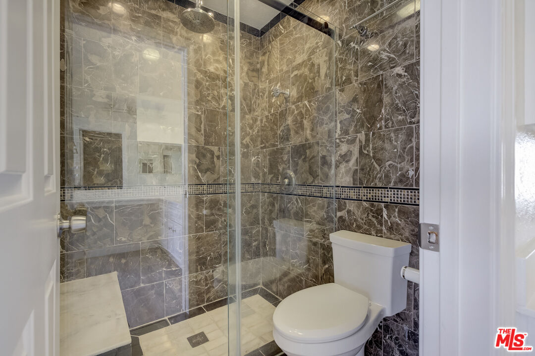 117 East Wilson Street, Unit C Costa Mesa, CA 92627 - Photo 20 of 23 a white toilet next to a bathroom shower