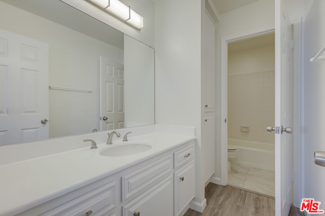 117 East Wilson Street, Unit C Costa Mesa, CA 92627 - Photo 21 of 23 a bathroom with a sink a mirror and a shower