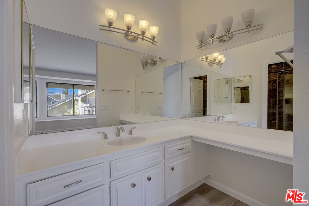 117 East Wilson Street, Unit C Costa Mesa, CA 92627 - Photo 4 of 23 a spacious bathroom with a sink a large mirror and vanity