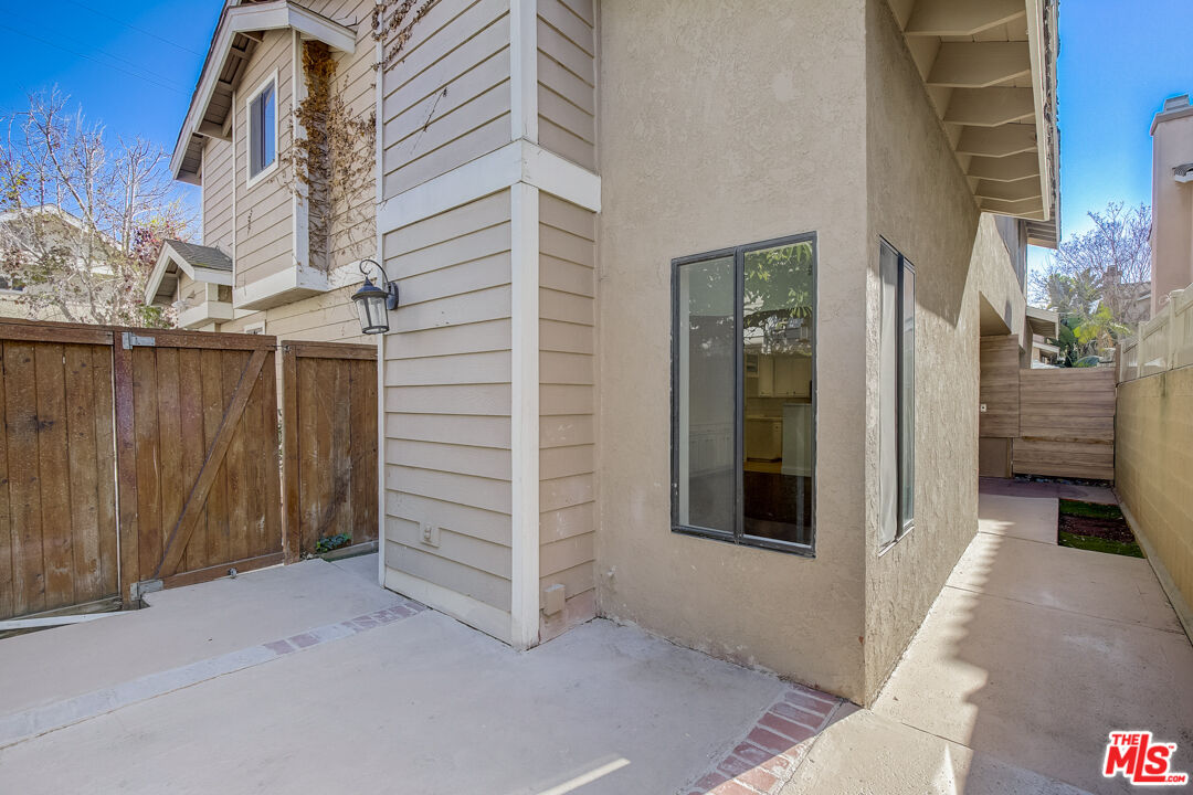 117 East Wilson Street, Unit C Costa Mesa, CA 92627 - Photo 5 of 23 a view of a house with a door and wooden walls