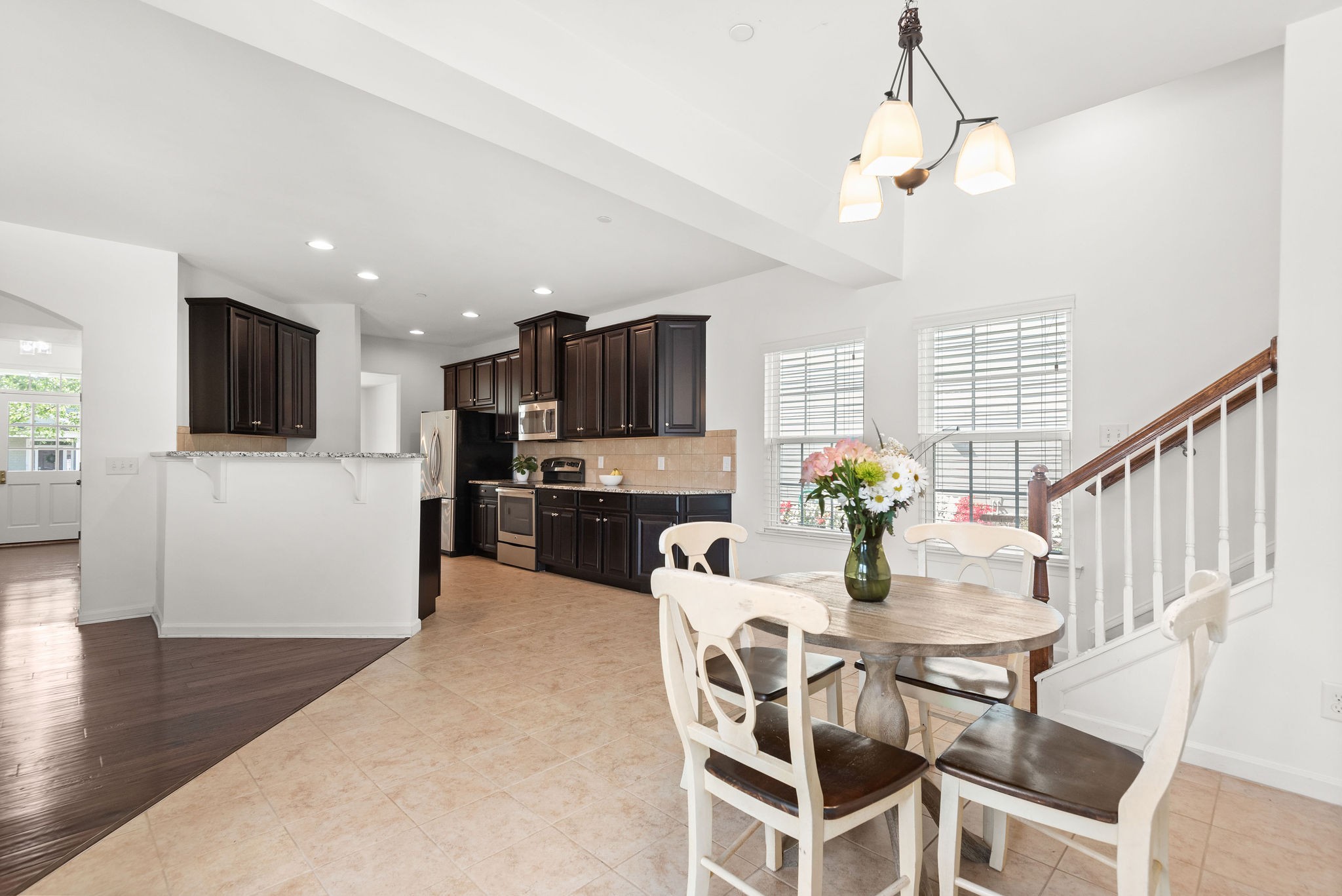 620 Streamside Lane Franklin, TN 37064 - Photo 15 of 45 a view of a dining room with furniture a kitchen and chandelier