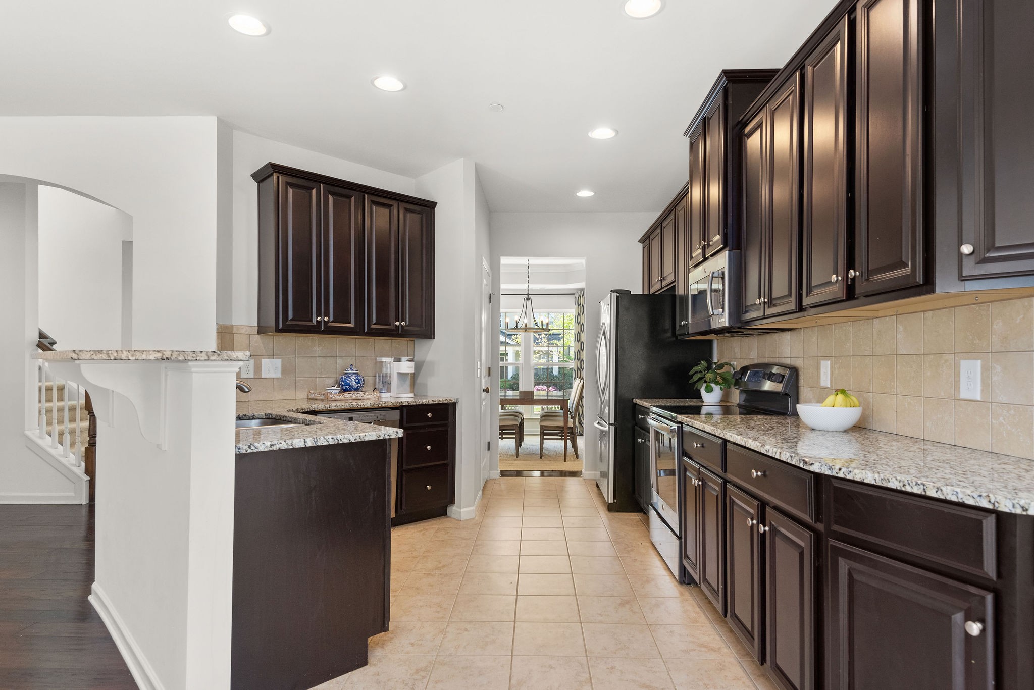 620 Streamside Lane Franklin, TN 37064 - Photo 9 of 45 a kitchen with stainless steel appliances granite countertop a stove top oven a sink dishwasher a refrigerator and cabinets with wooden floor