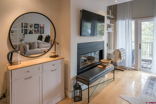 a living room with furniture a fireplace and a flat screen tv