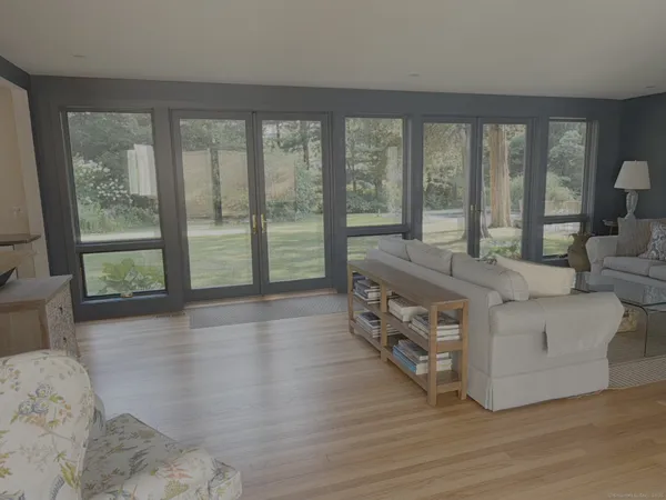 a living room with furniture and large windows