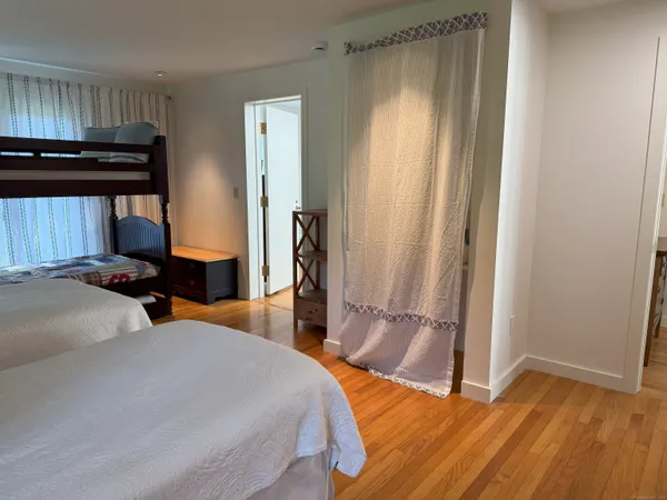 a bed room with a bed and a mirror