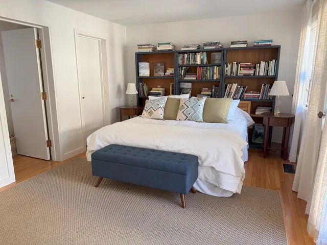 a bedroom with a bed and a book shelf