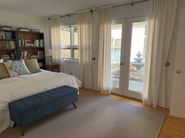 a spacious bedroom with a bed and a large window