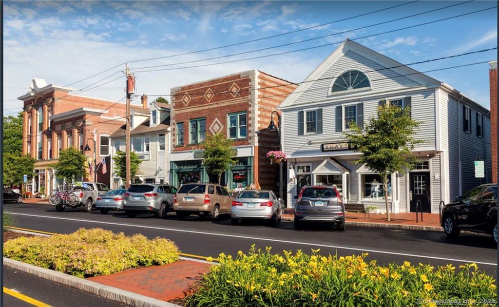 56 Island Avenue Madison, CT 06443 - Photo 24 of 25 a front view of a building with lots of cars and trees in the background