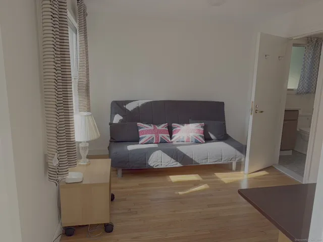 a bedroom with bed and a window