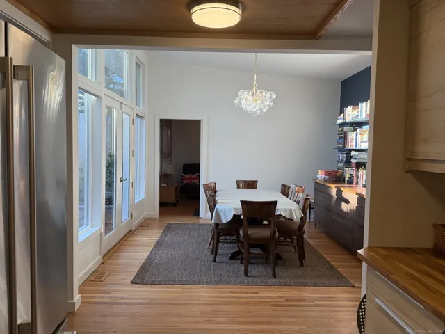 a view of a dining room with furniture and chandelier