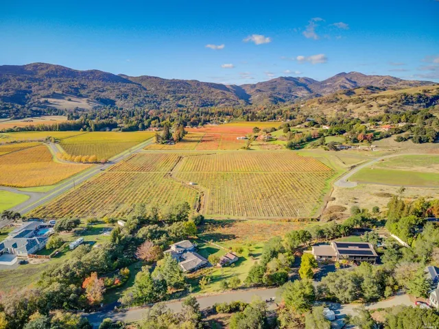 an aerial view of ocean and residential houses with outdoor space