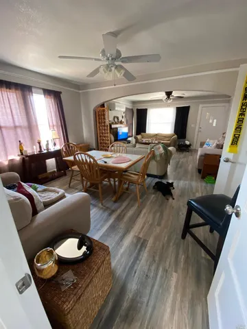 a living room with furniture and wooden floor