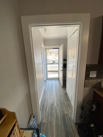 a view of a kitchen from a hallway