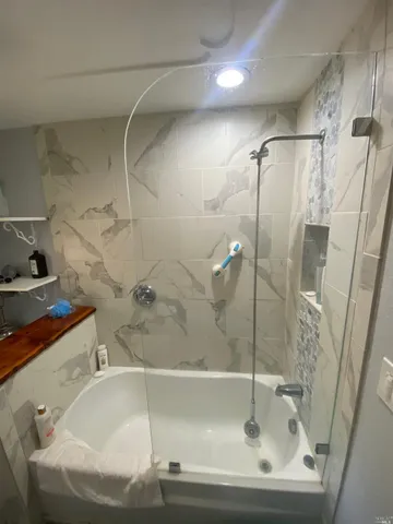 a bathroom with a tub and a shower