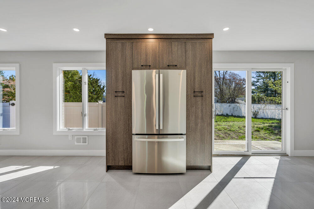 17 Spicy Pond Road Howell, NJ 07731 - Photo 11 of 44 a kitchen with stainless steel appliances granite countertop a refrigerator and a glass door