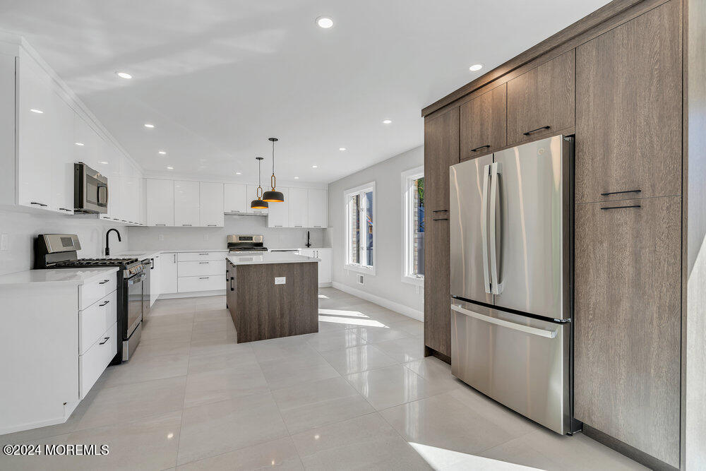 17 Spicy Pond Road Howell, NJ 07731 - Photo 12 of 44 a kitchen with a refrigerator a sink and a stove top oven