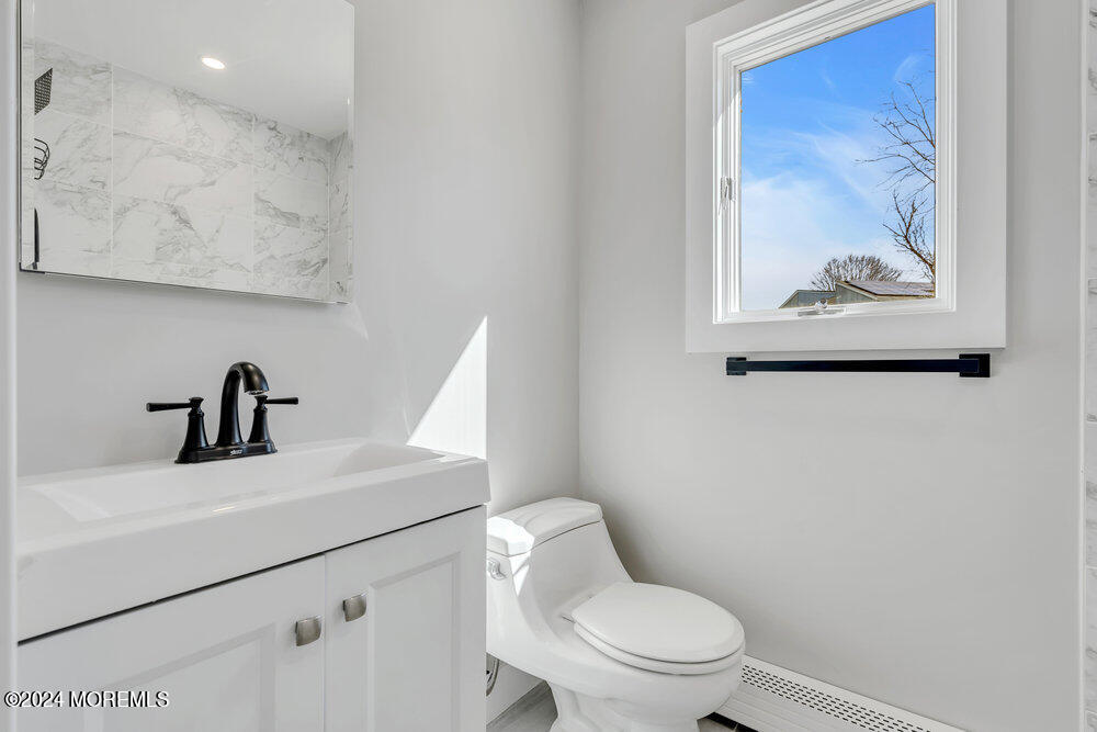 17 Spicy Pond Road Howell, NJ 07731 - Photo 19 of 44 a bathroom with a toilet sink and mirror