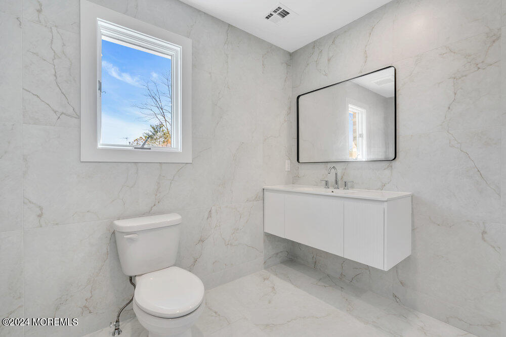 17 Spicy Pond Road Howell, NJ 07731 - Photo 37 of 44 a bathroom with a toilet a sink and mirror