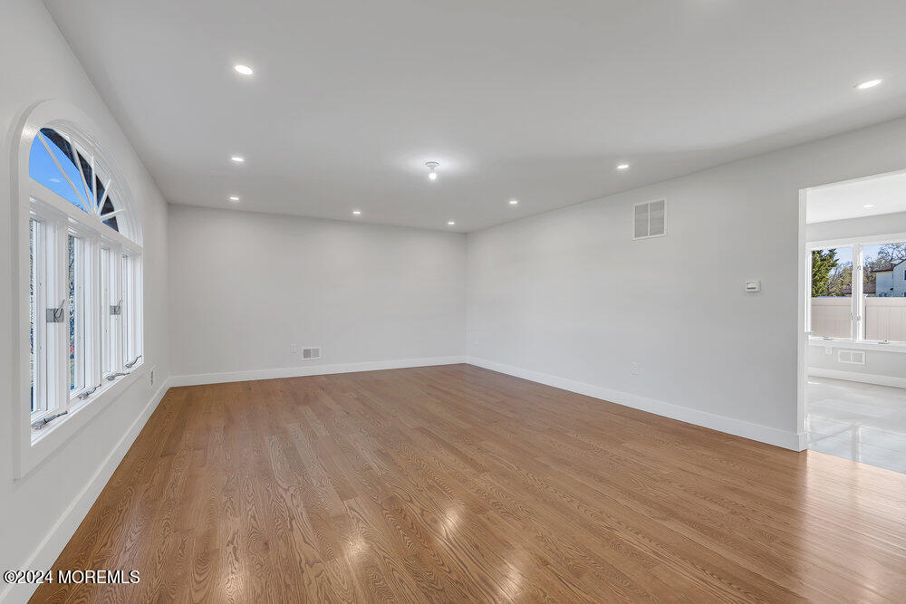 17 Spicy Pond Road Howell, NJ 07731 - Photo 6 of 44 an empty room with wooden floor and windows