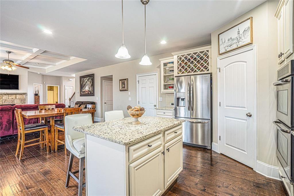 3478 In Bloom Way Auburn, GA 30011 - Photo 14 of 32 a kitchen with a refrigerator a table and chairs