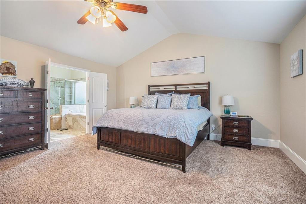 3478 In Bloom Way Auburn, GA 30011 - Photo 16 of 32 a bedroom with a bed and a chandelier
